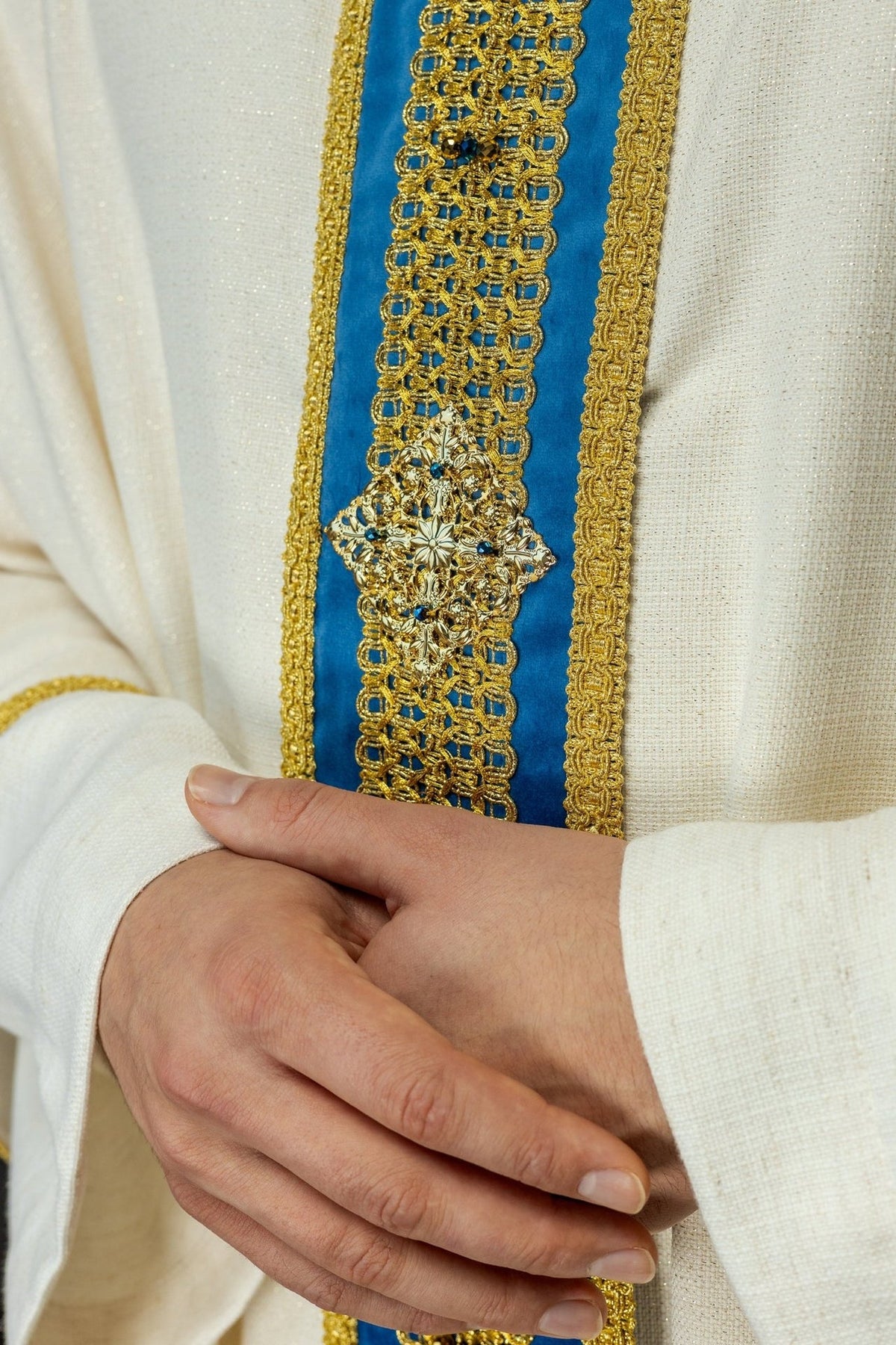 Handcrafted chasuble close-up of blue and gold front orphrey with natural stones