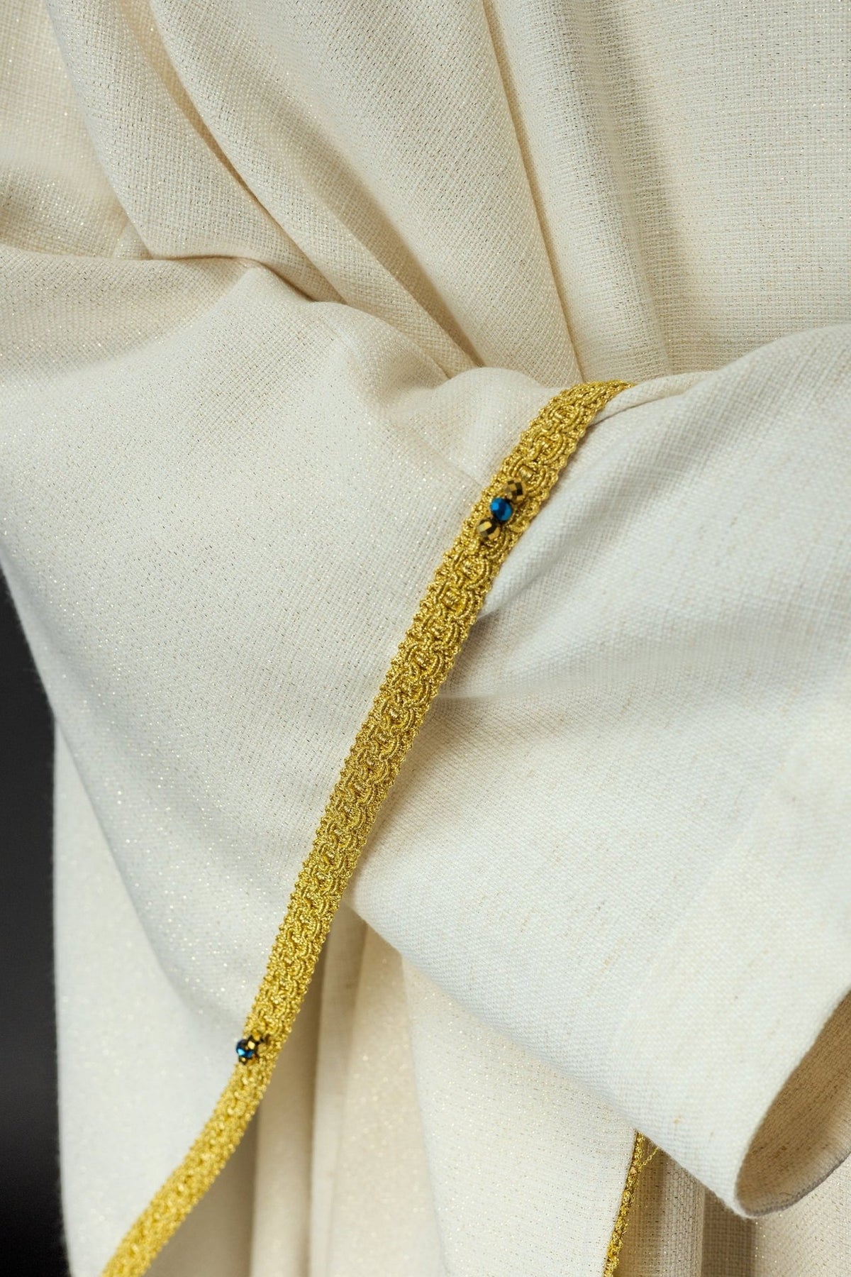 Handcrafted chasuble close-up of blue and gold orphrey with embedded natural stones