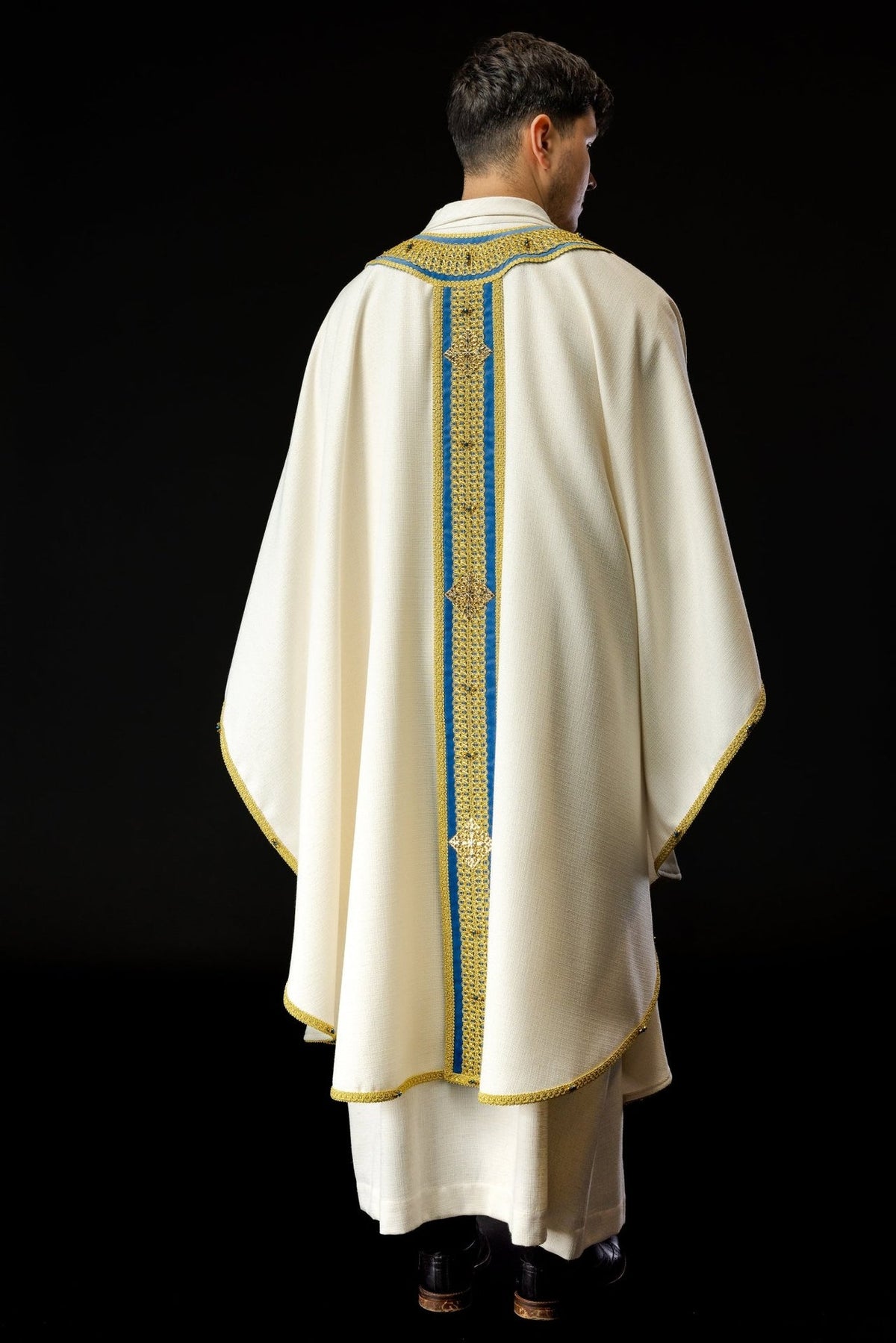 Handcrafted chasuble back view with blue and gold orphrey and ivory fabric