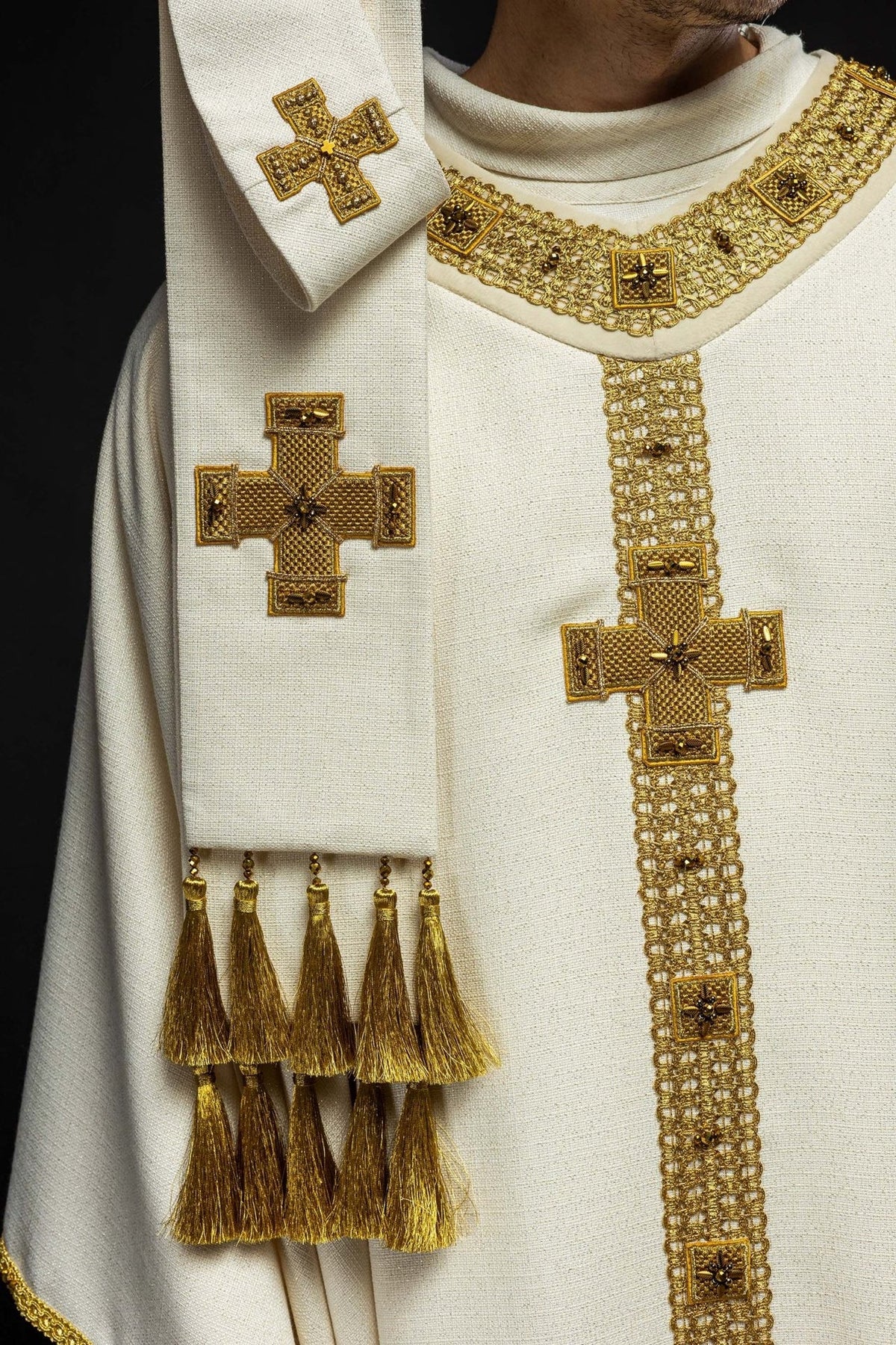 Ecru chasuble front detail with gold cross, embroidery and tassel