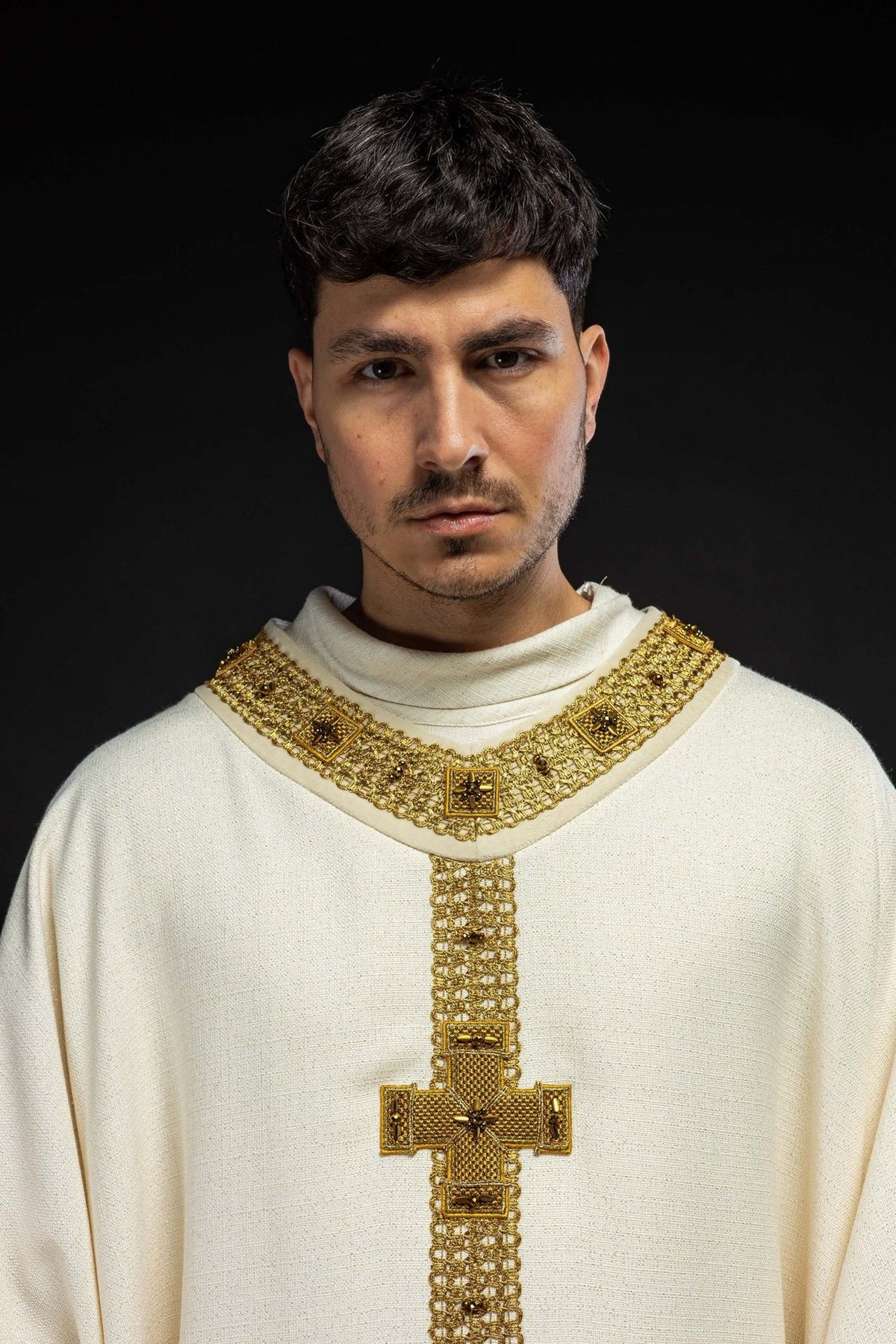 Ecru chasuble close-up with gold collar and cross embroidery