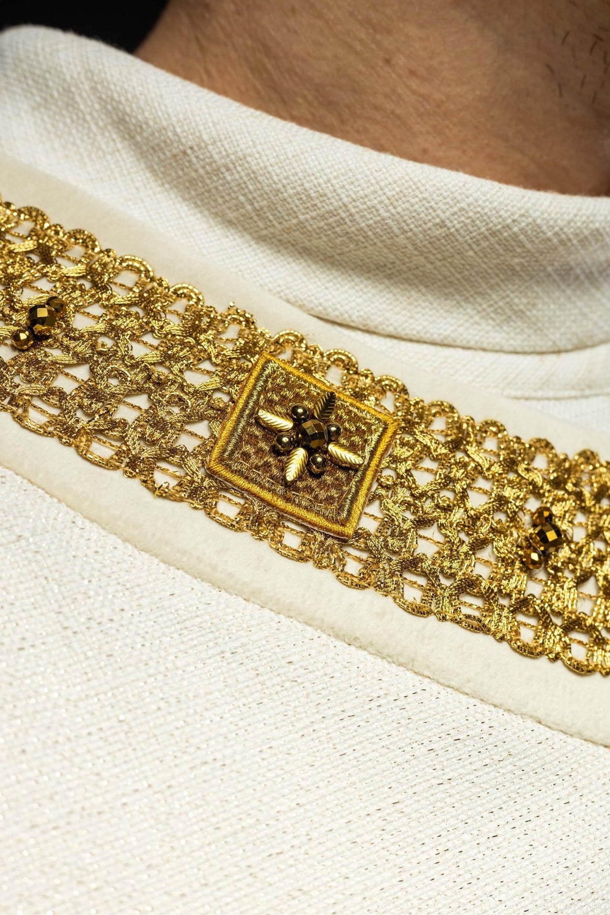 Ecru chasuble gold collar close-up with square stone embellishments