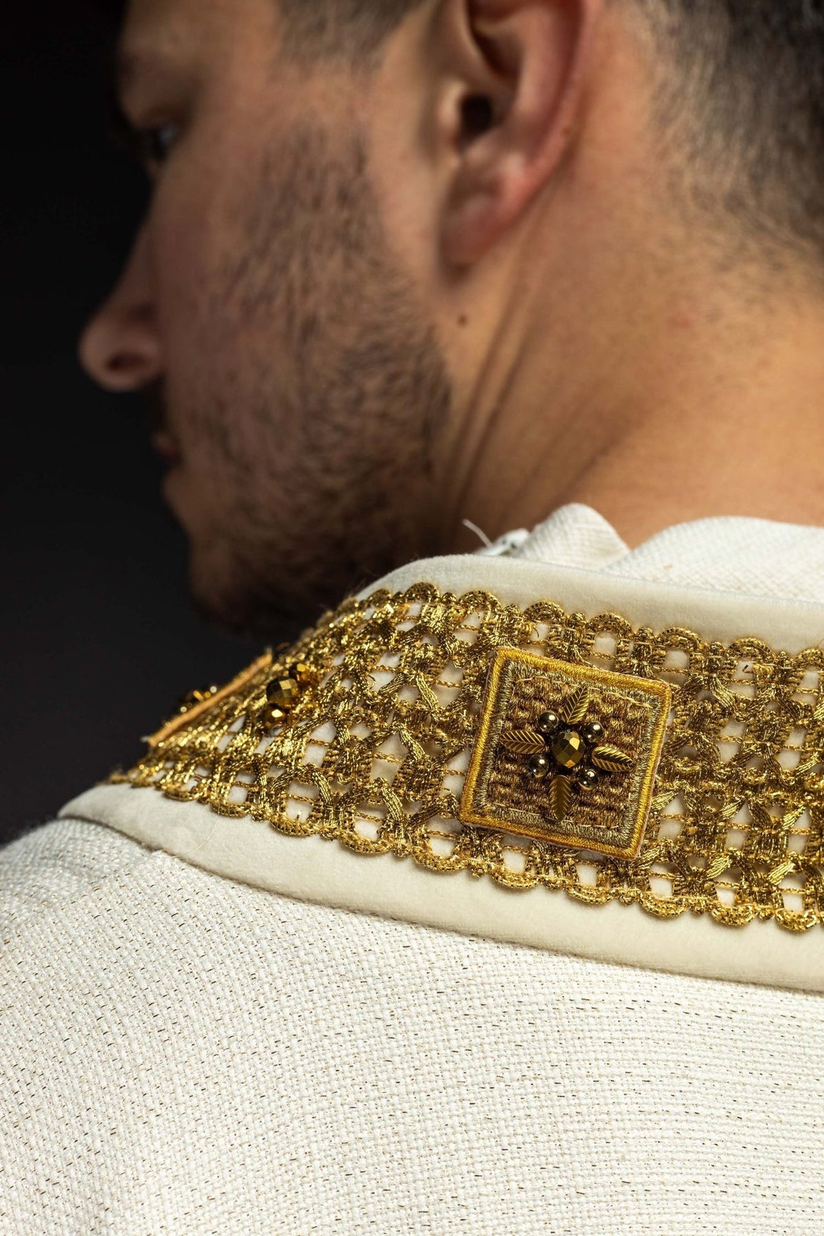 Ecru chasuble collar close-up with gold embroidery and natural stones