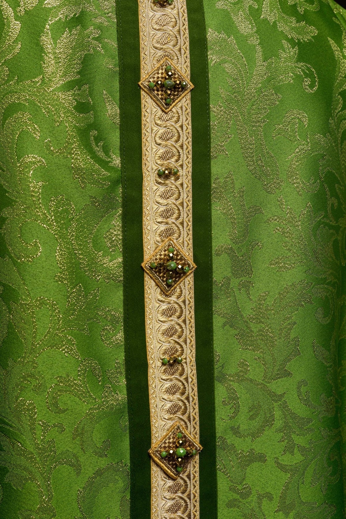 Green chasuble detail showing gold orphrey embroidery and natural stones