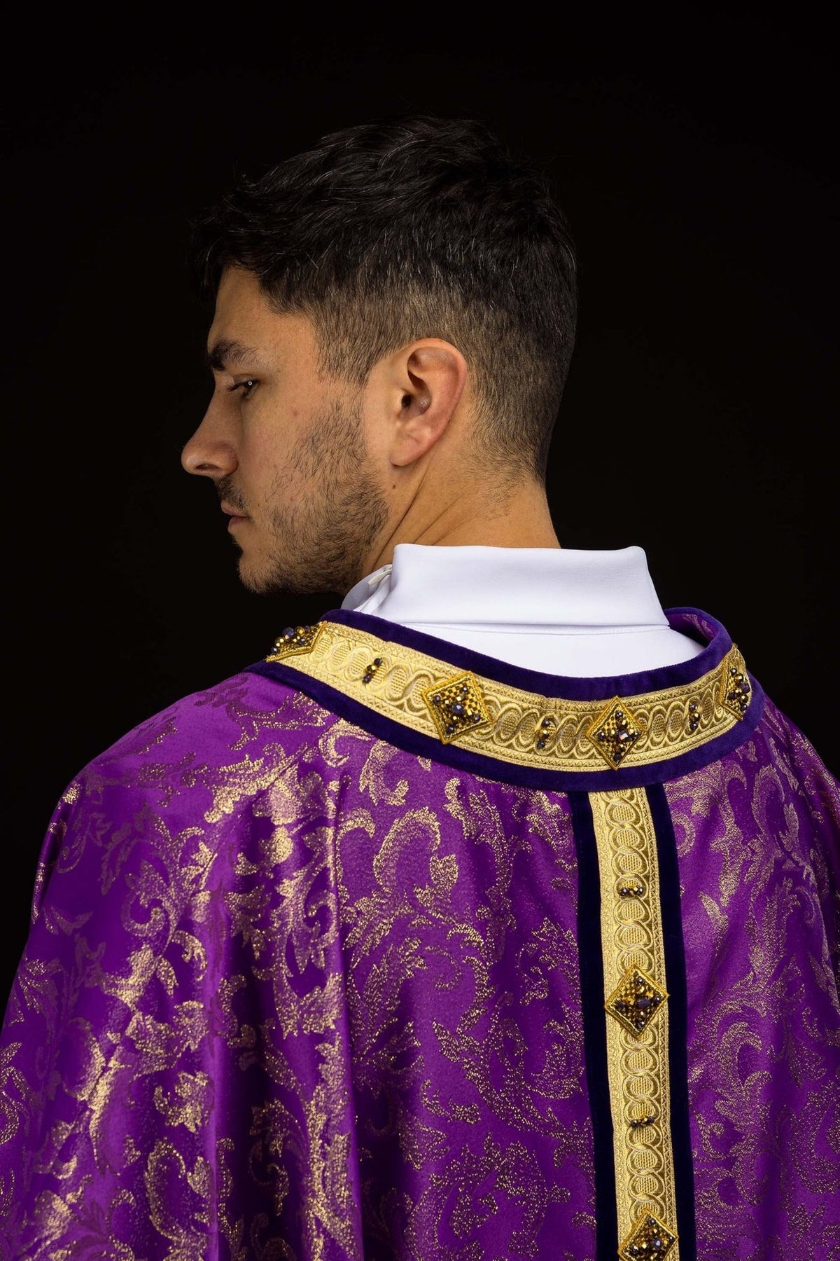 Purple chasuble back view with gold orphrey, jeweled collar and jacquard motifs