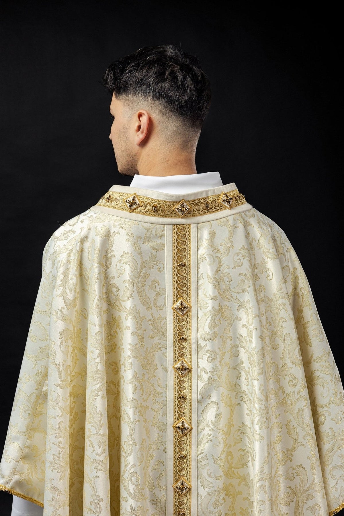 Chasuble back close-up showing gold collar embroidery and central orphrey