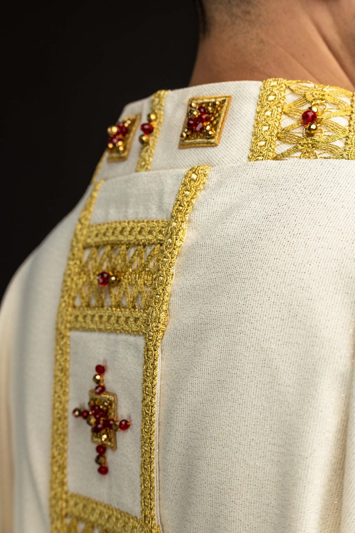 Handcrafted chasuble with natural stones, close-up of gold embroidered panel