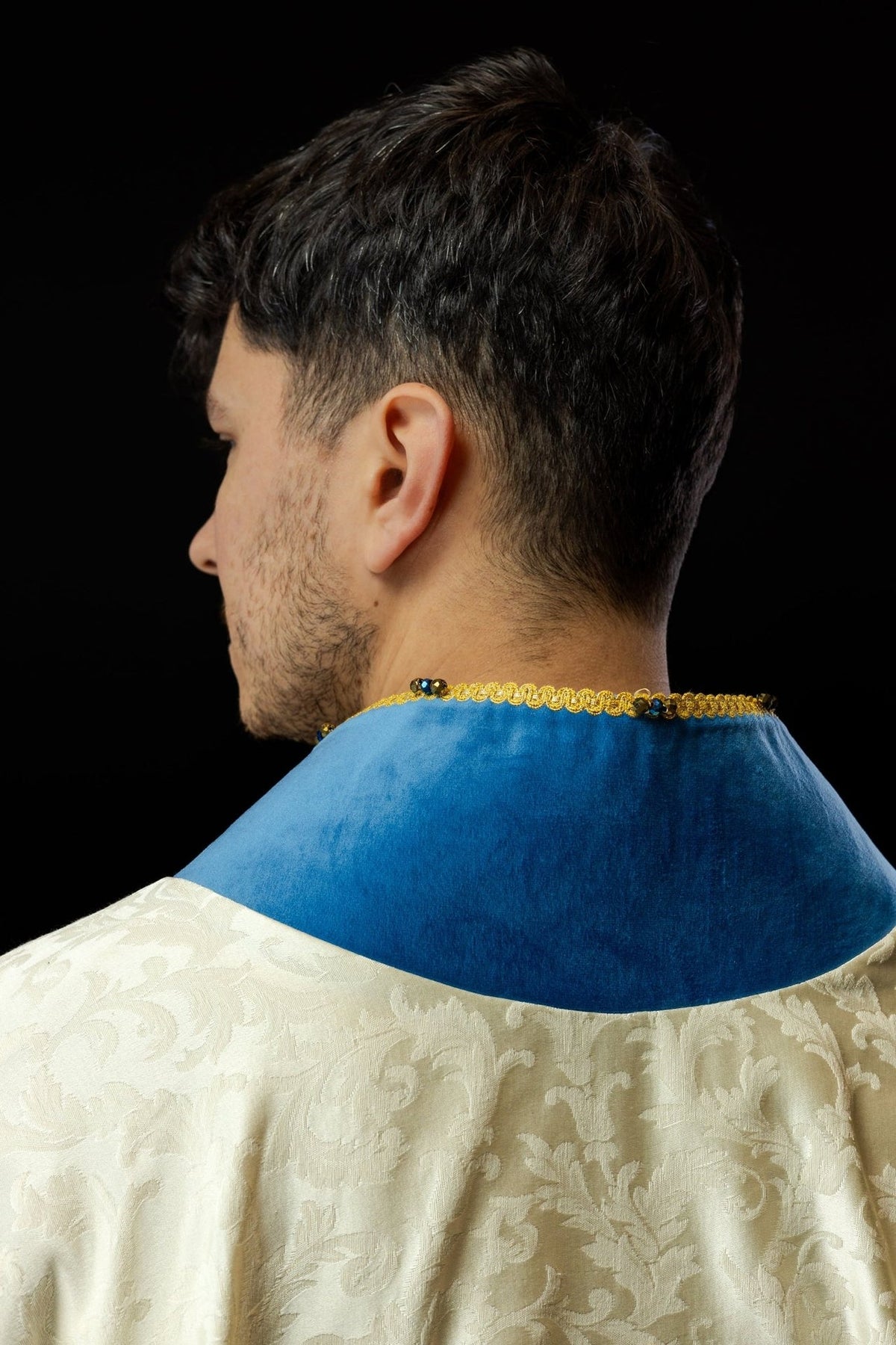 Marian chasuble back view with embroidered Marian symbol and blue velvet trim