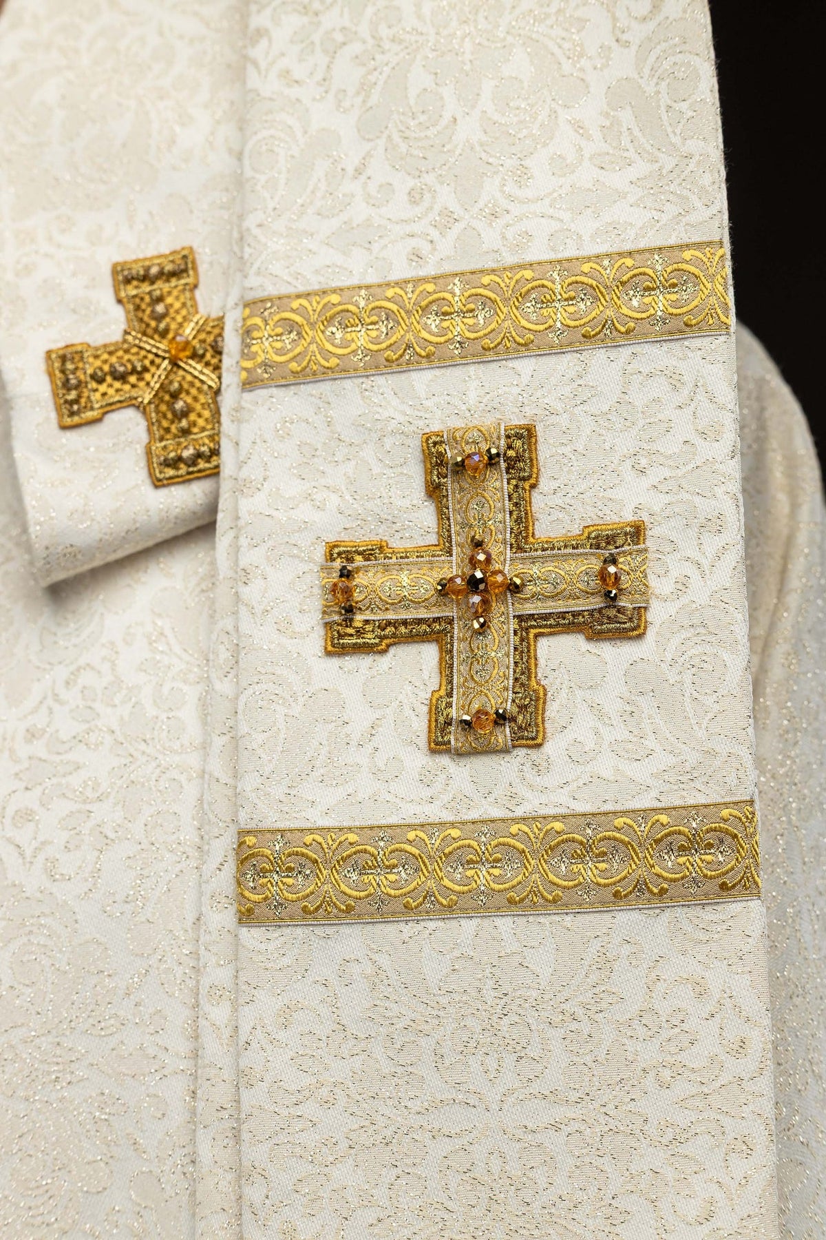 Chasuble close-up of gold tassels with faceted bead accents