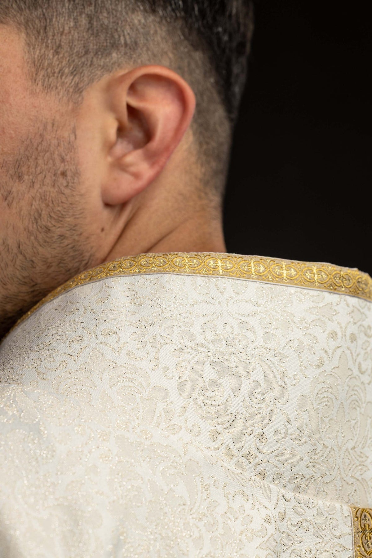 Chasuble close-up of jeweled cross and gold embroidered central band