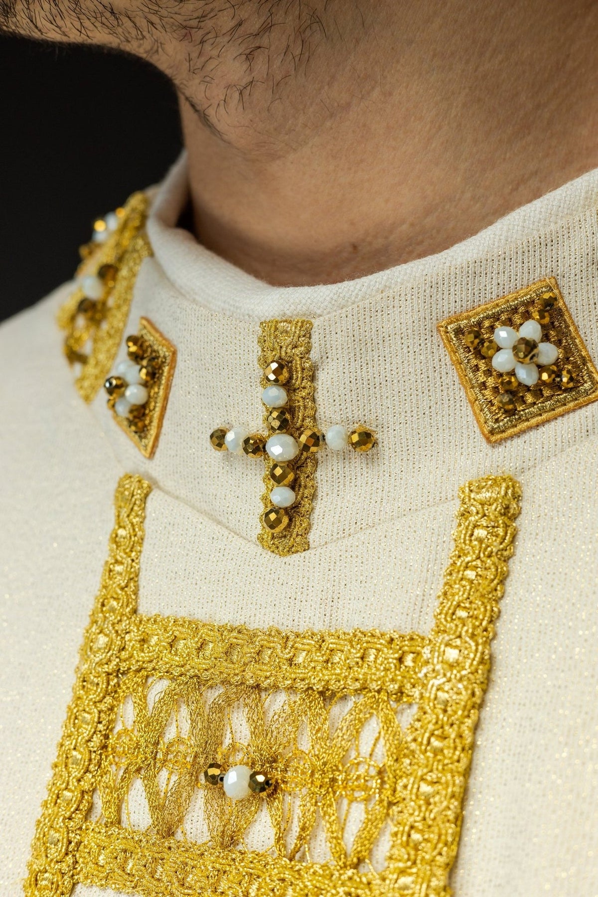 Chasuble orphrey detail with a beaded cross and gold embroidery