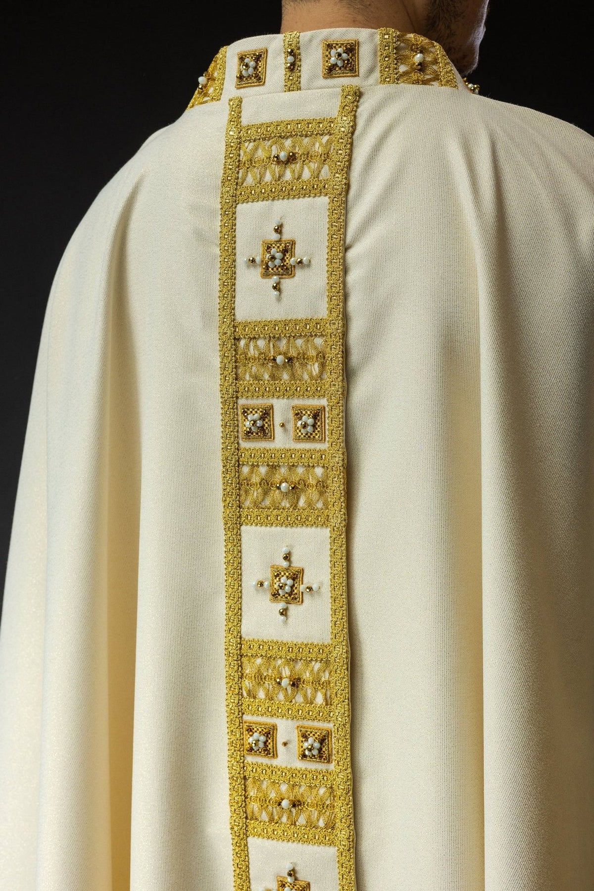 Chasuble back close-up with gold orphrey and beaded cross motifs