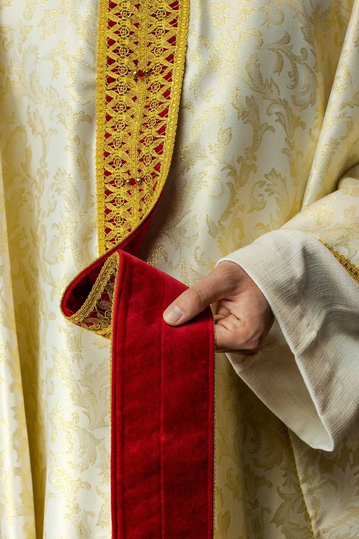 Handcrafted chasuble front detail with red velvet panel and gold cross embroidery