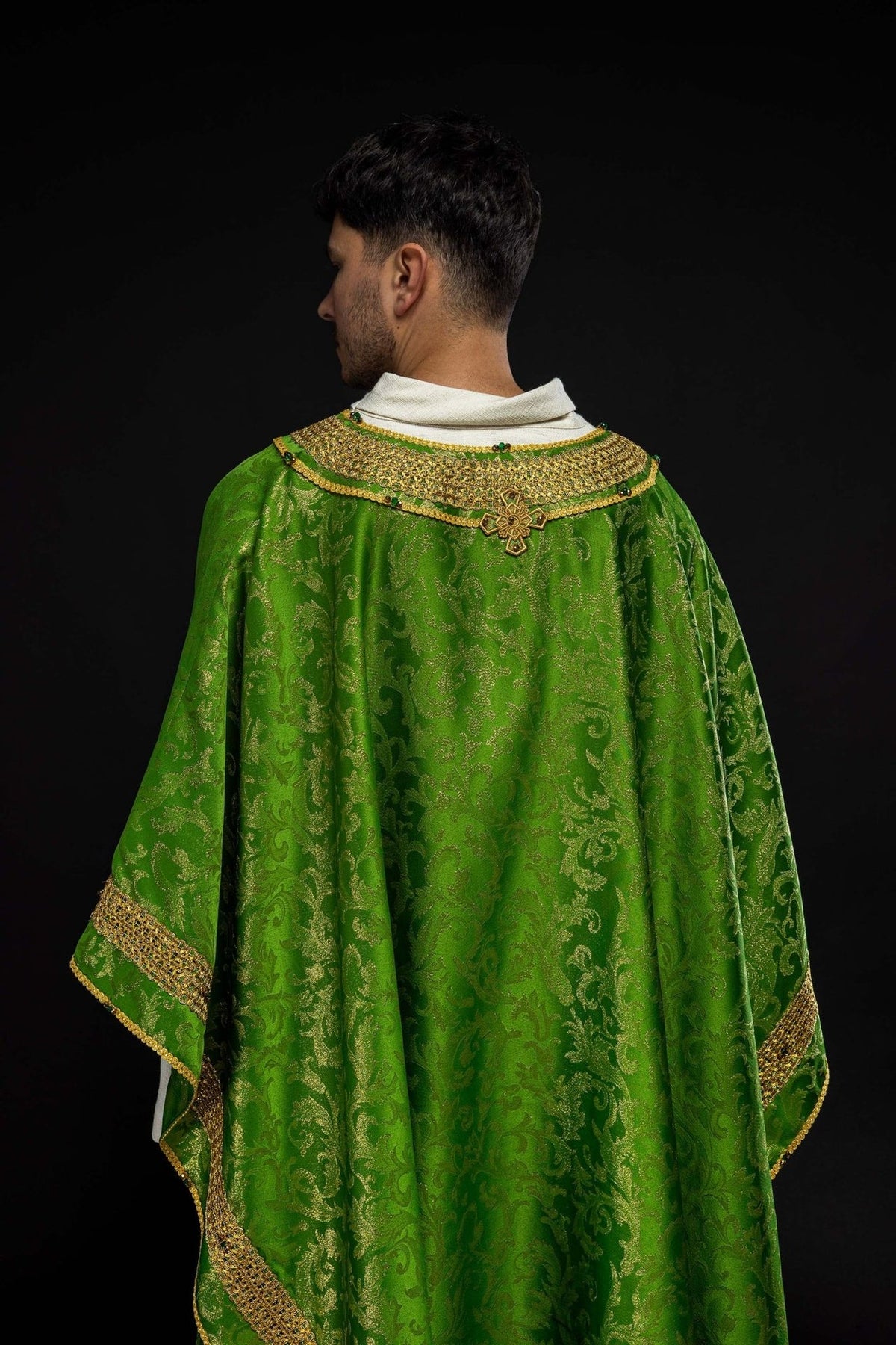 Green chasuble back view with gold embroidery, patterned jacquard fabric and trim