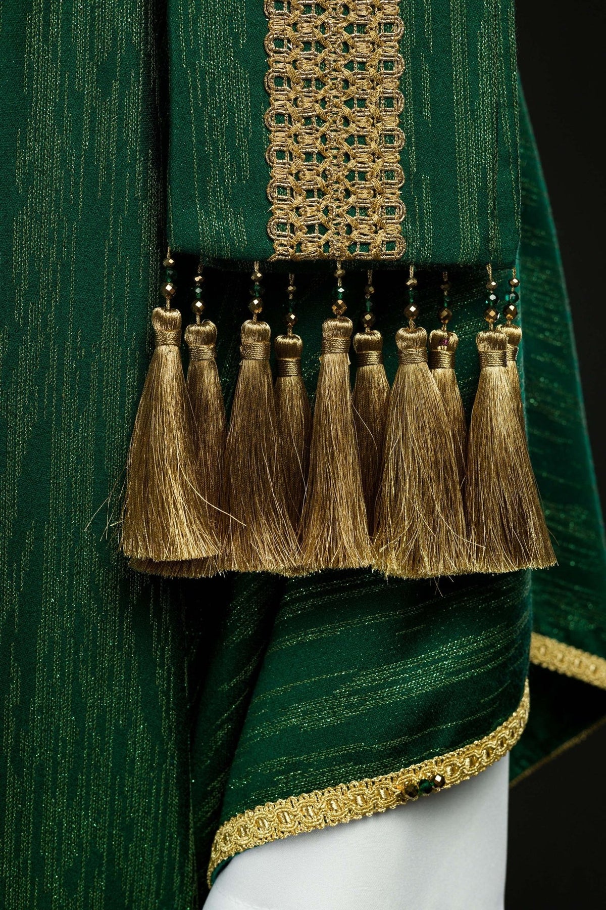 Green chasuble front detail with cross embroidery, gold trim and tassel