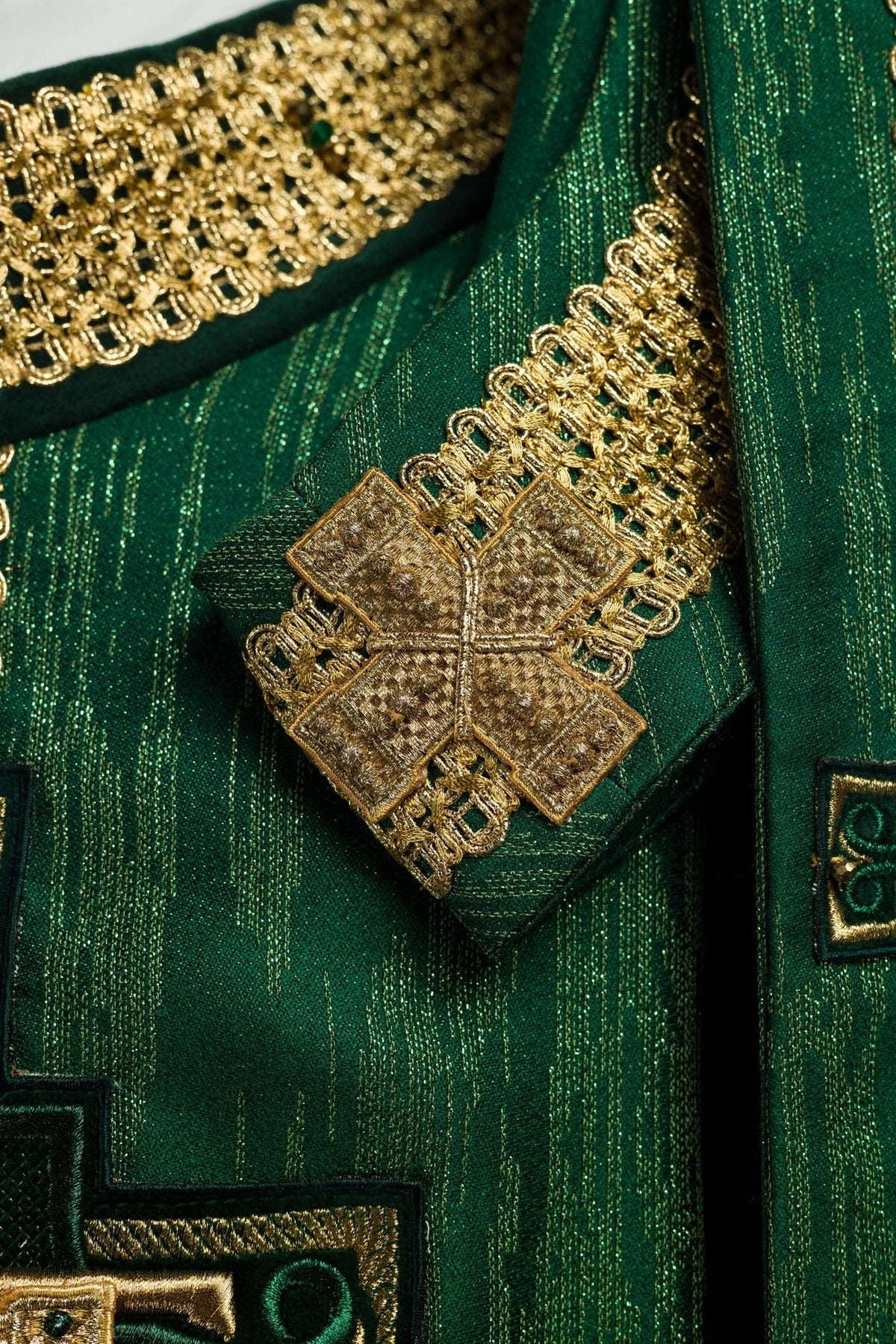 Green chasuble sleeve detail with gold tassel and trim