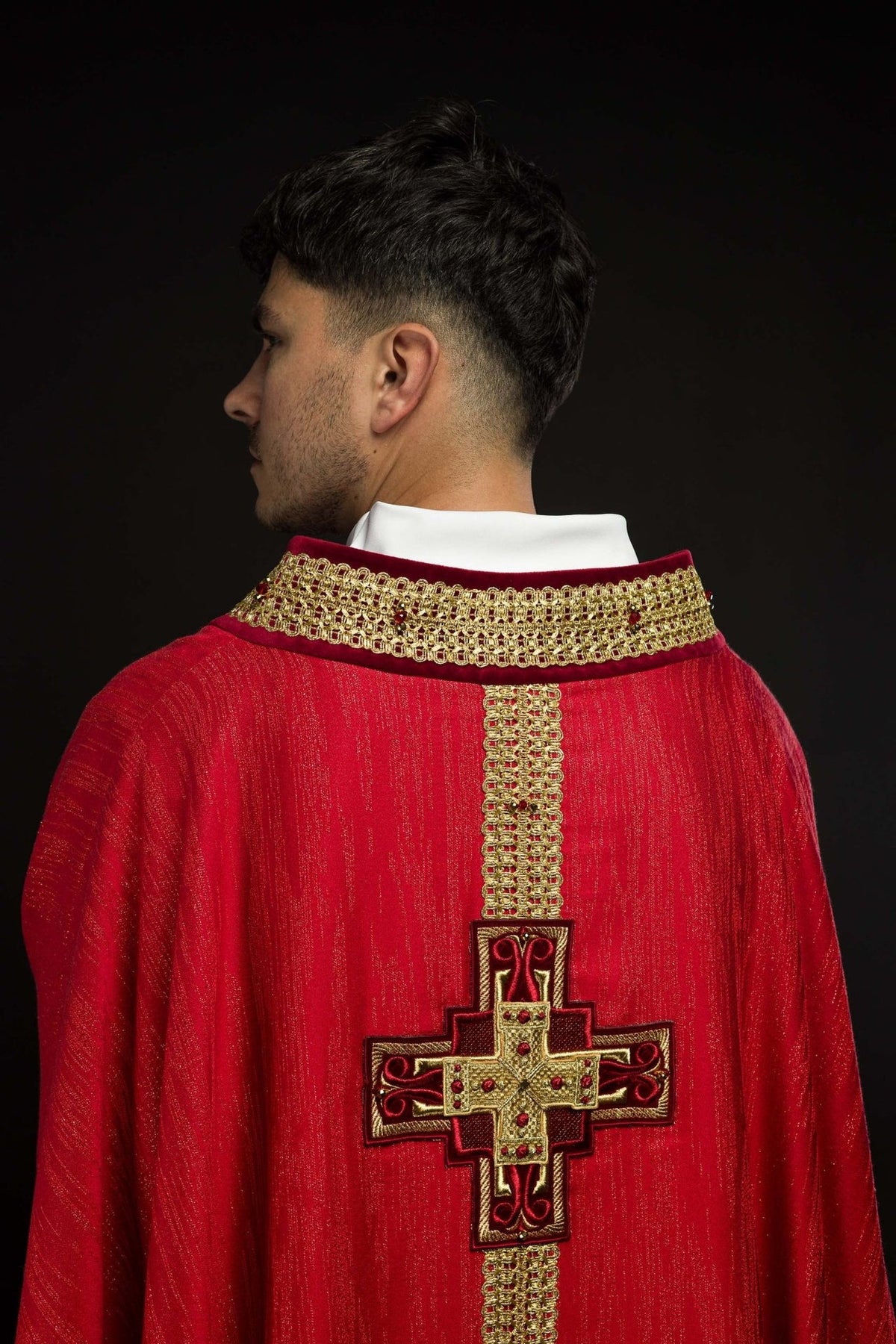 Handcrafted red chasuble back close-up with gold cross embroidery and ornate gold trim