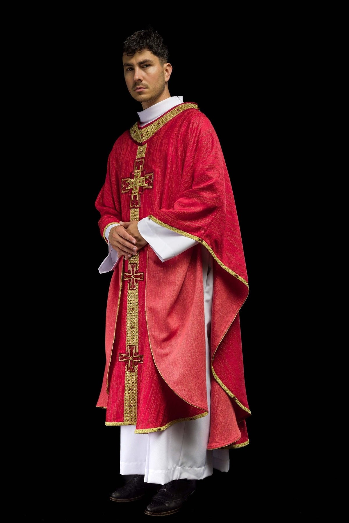 Handcrafted red chasuble worn, front three-quarter view with gold cross embroidery