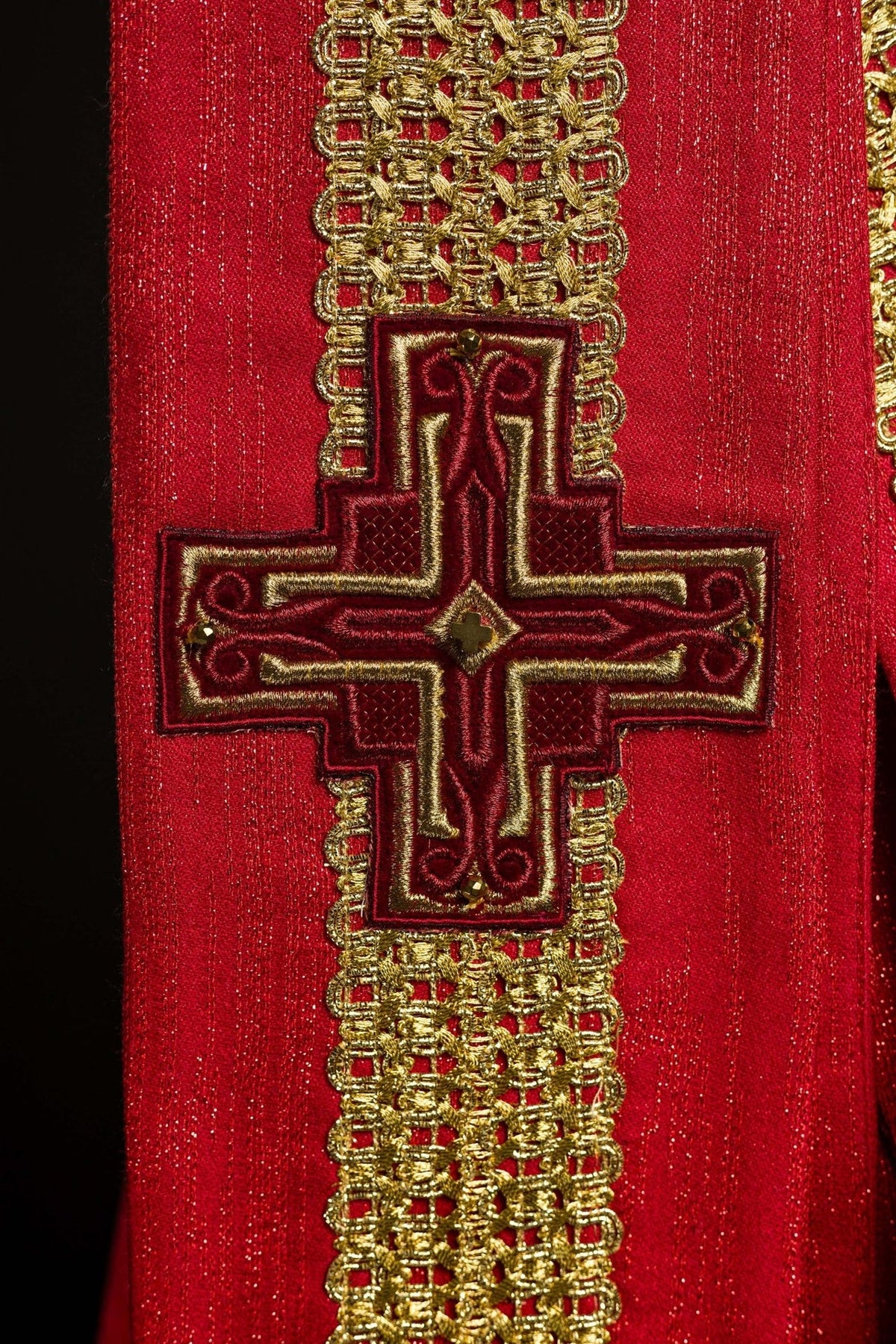 Red chasuble close-up of lower cross embroidery and gold trim