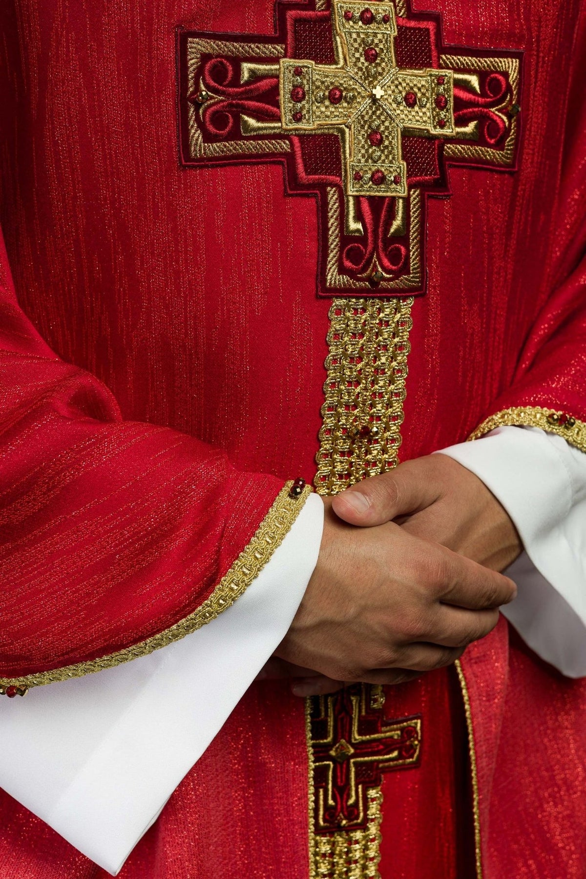 Red chasuble detail of gold trim, red fabric and sleeve edging