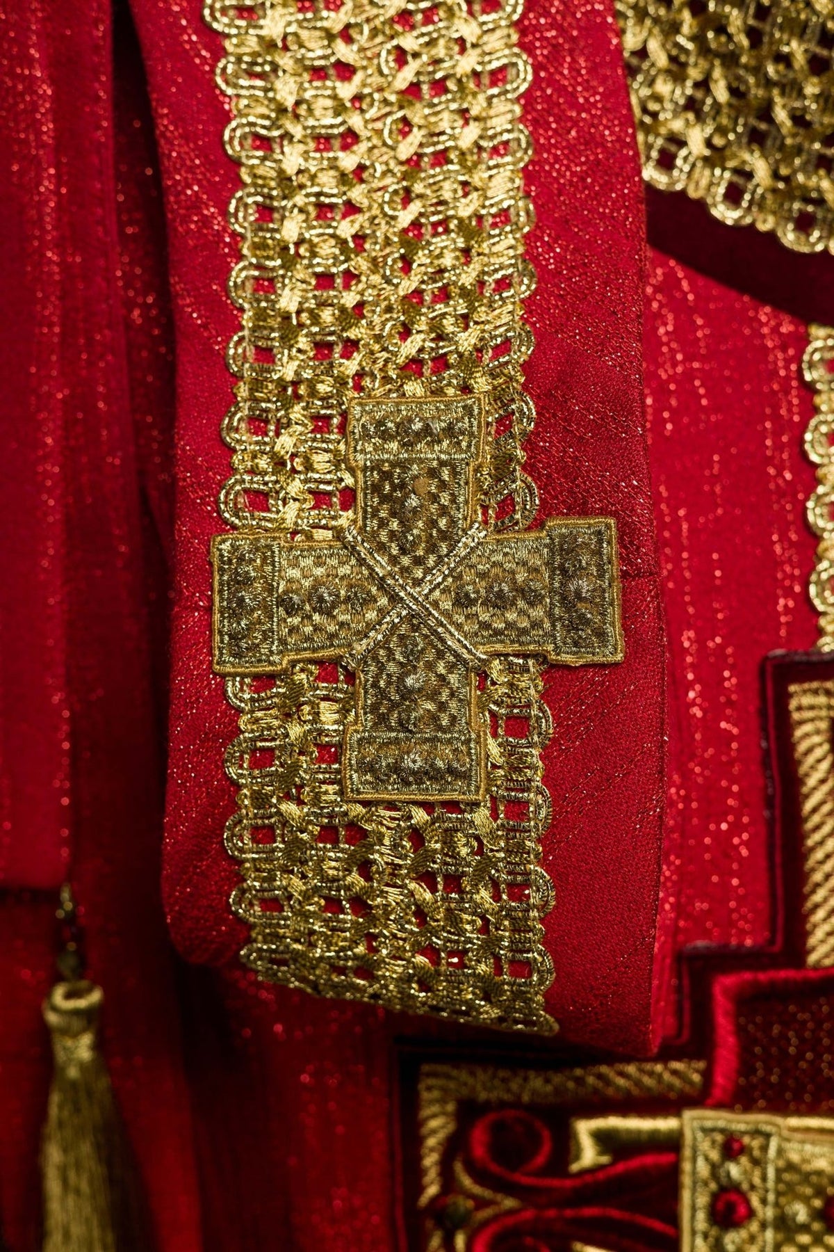 Red chasuble close-up of gold cross embroidery on matching stole