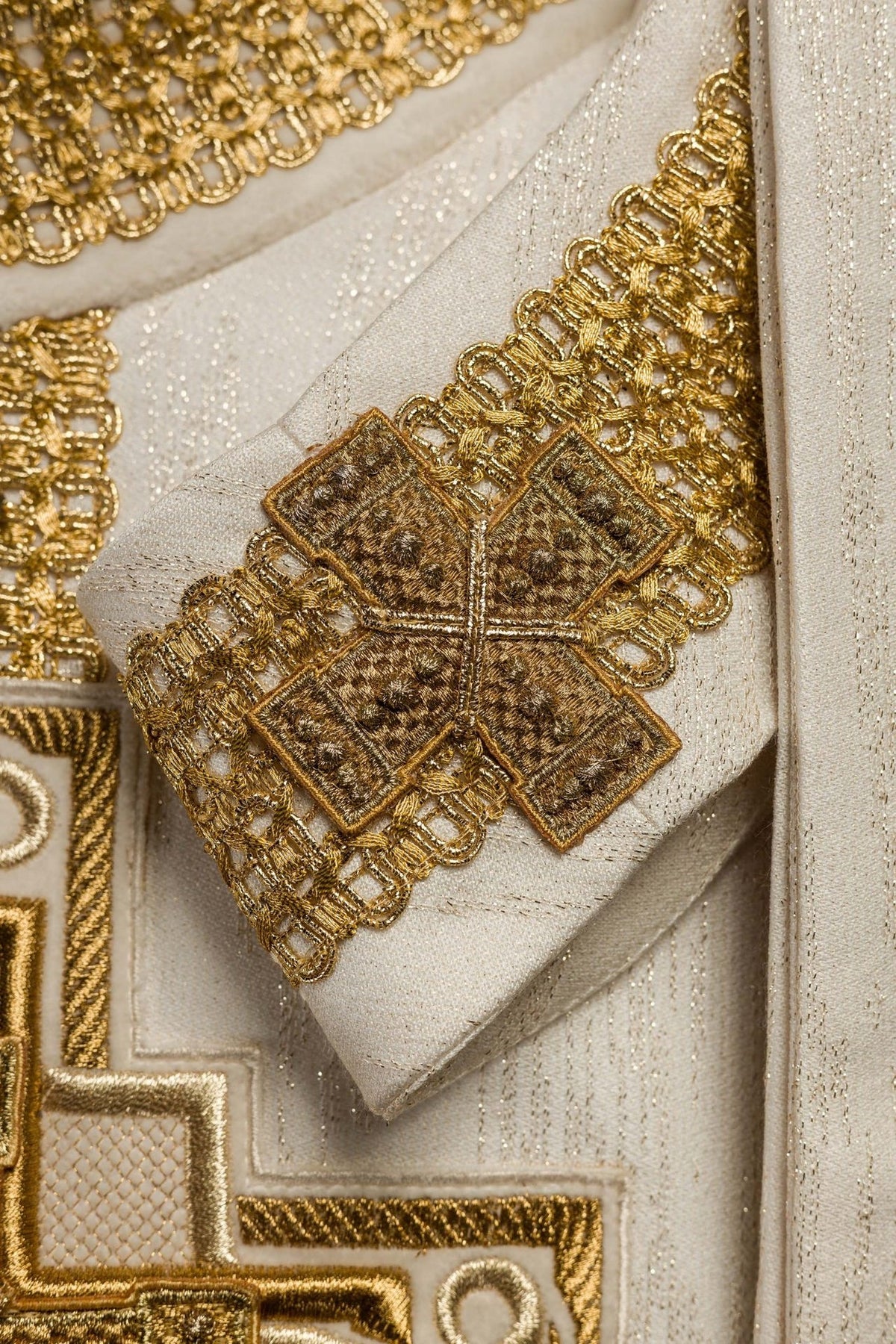 Chasuble close-up of gold cross embroidery on the sleeve