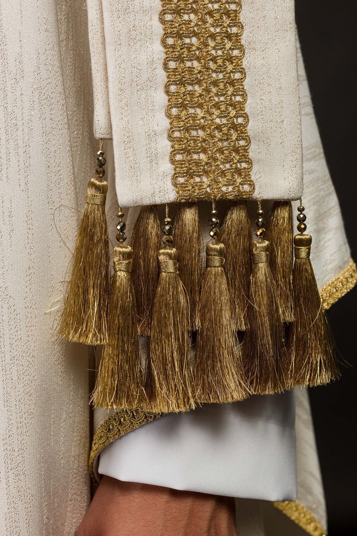 Chasuble sleeve close-up with gold embroidery and tassel trim