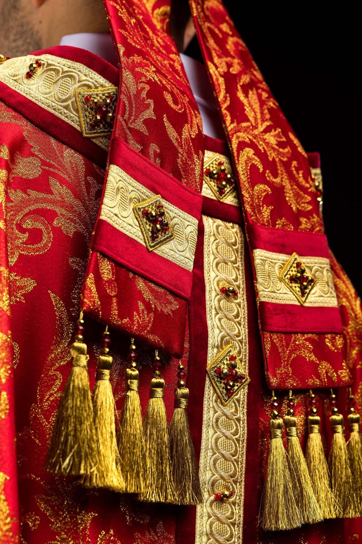 Miter close-up showing gold band, red velvet and crystal-set trim