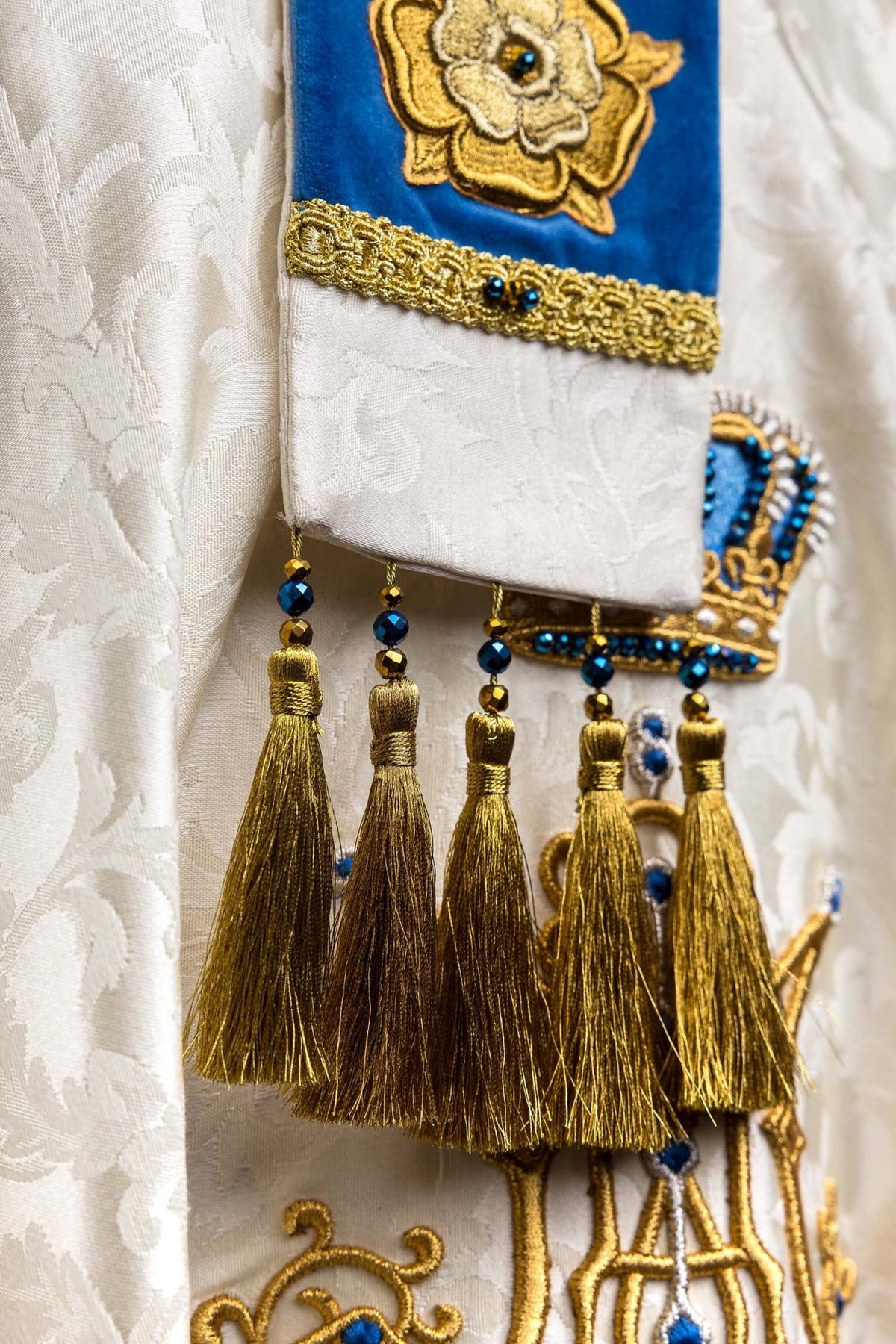 Close-up of Marian miter detail with blue stones and hanging gold tassel