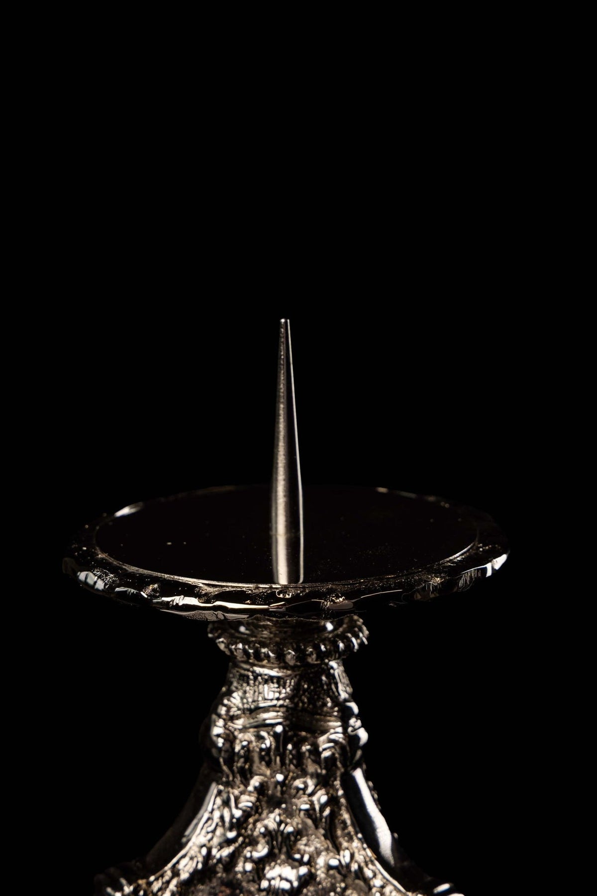 Nickel-plated brass candlestick close-up of tray, spike and embossed base