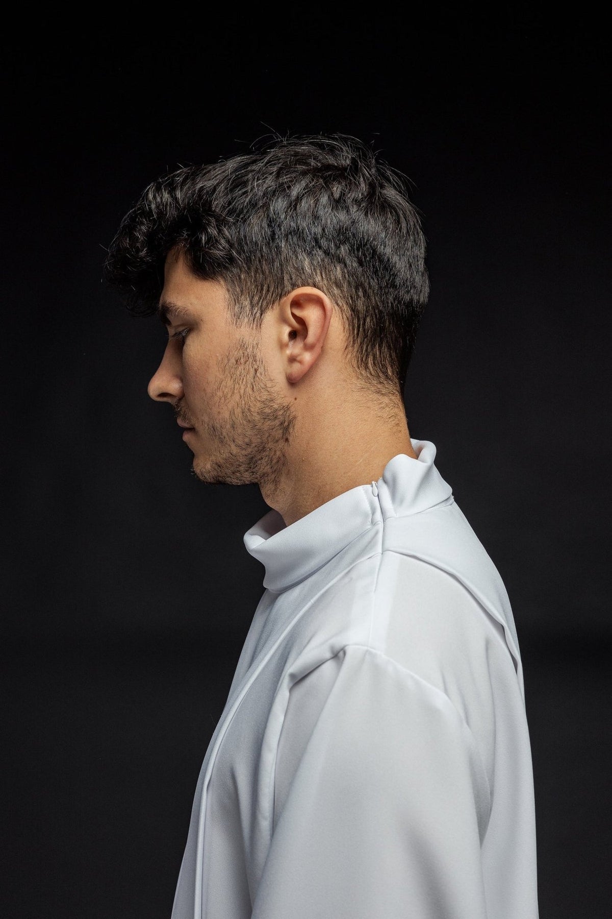 White priest alb side view showing the stand-up collar and shoulder fastening