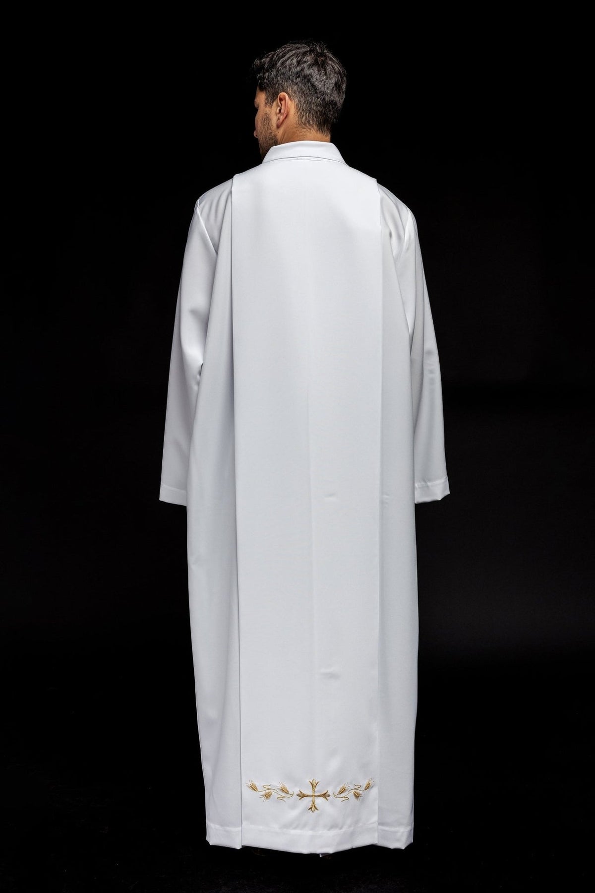 White priest alb back view with gold cross and wheat embroidery at the hem