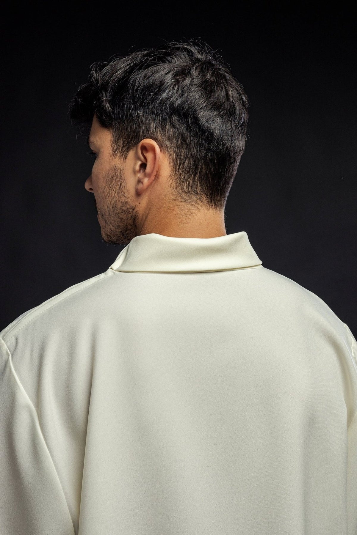 Ecru alb close-up from the back, showing the plain fabric and collar