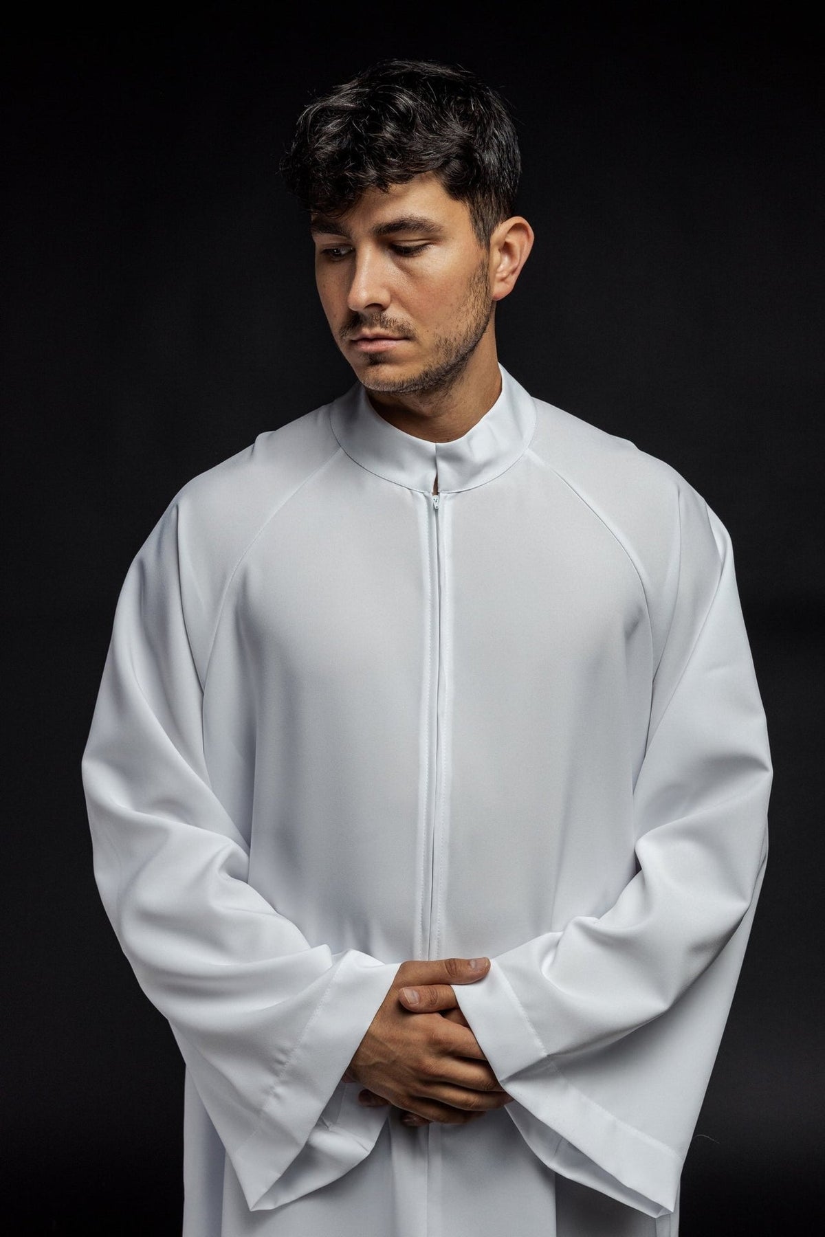 White priest alb close-up showing the stand collar and front zipper