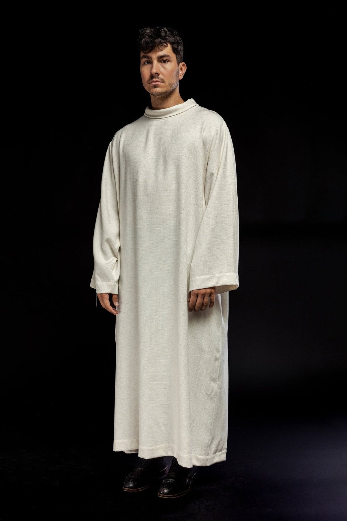 Linen priest alb in ecru, three-quarter front view with rolled collar and wide sleeves