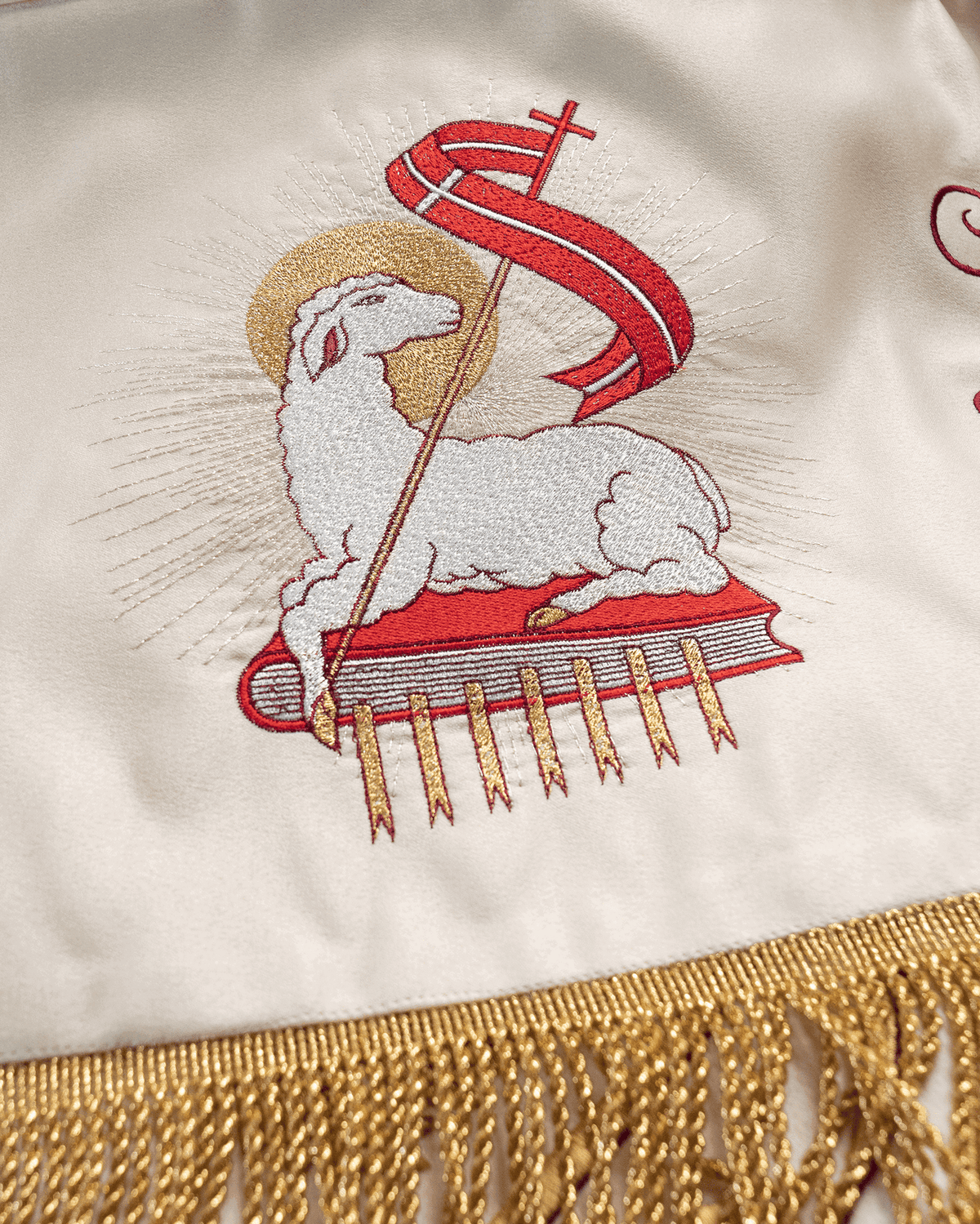 Corpus Christi canopy close-up of embroidered Agnus Dei motif and gold fringe