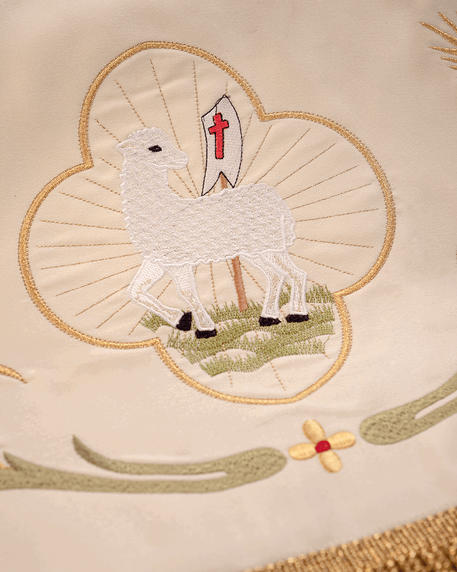 Corpus Christi canopy close-up showing embroidered Agnus Dei lamb medallion