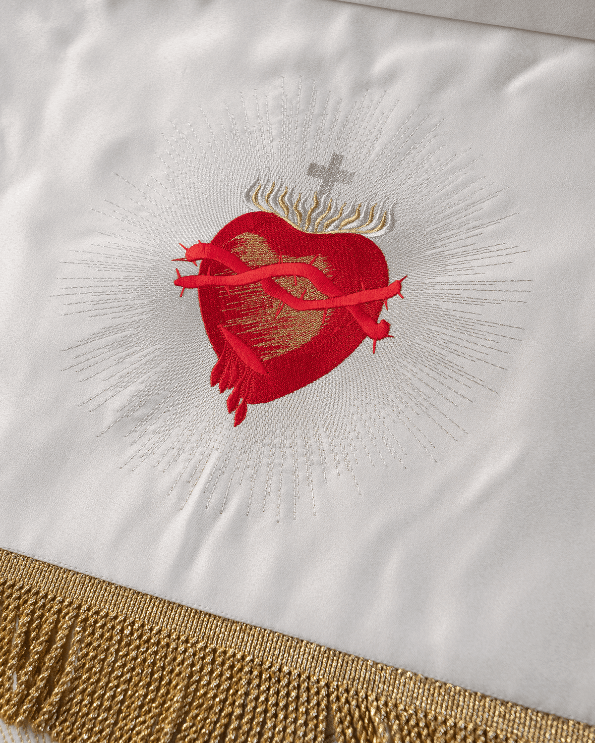 Processional canopy close-up of embroidered Sacred Heart of Jesus in red, white and gold