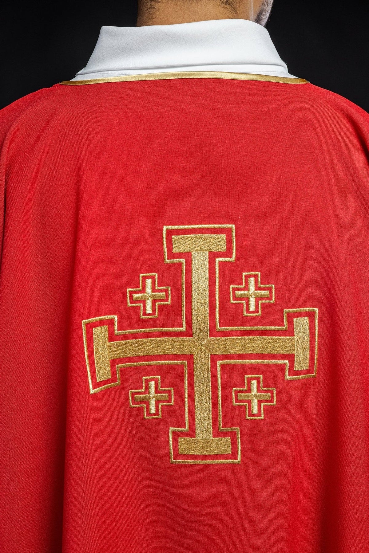 Red dalmatic back close-up with embroidered gold cross