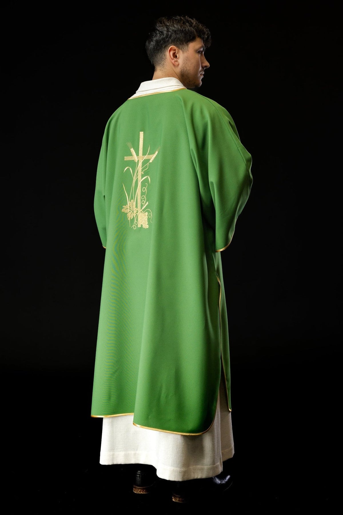 Green dalmatic, back three-quarter view with gold trim and embroidered cross