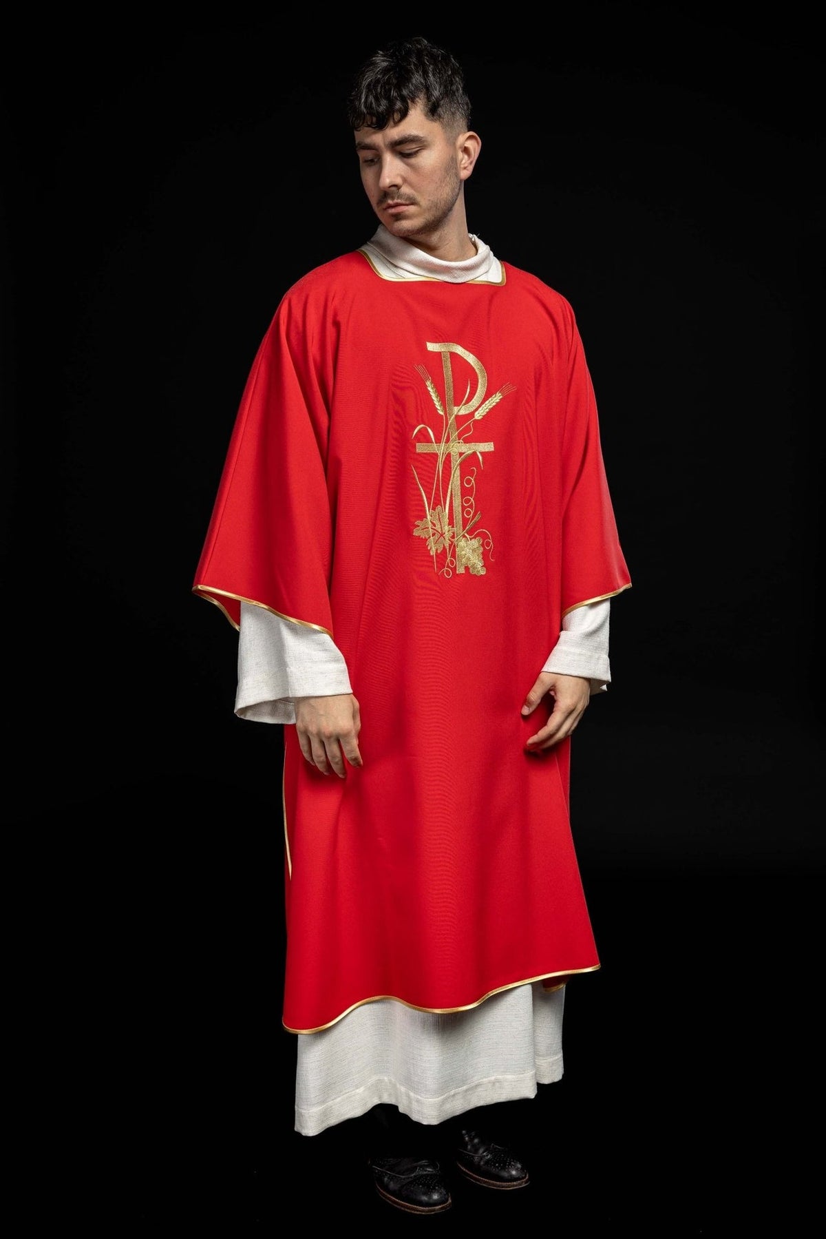 Red dalmatic front view showing gold Pax cross embroidery and gold trim