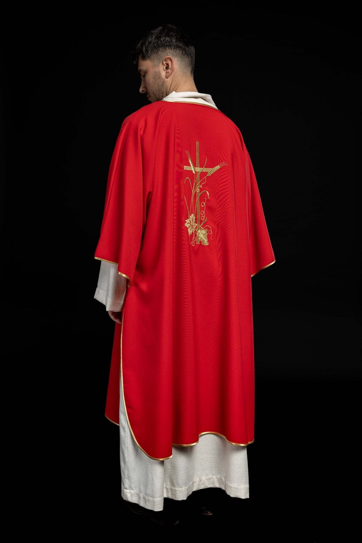 Red dalmatic rear three-quarter view with gold trim and back embroidery