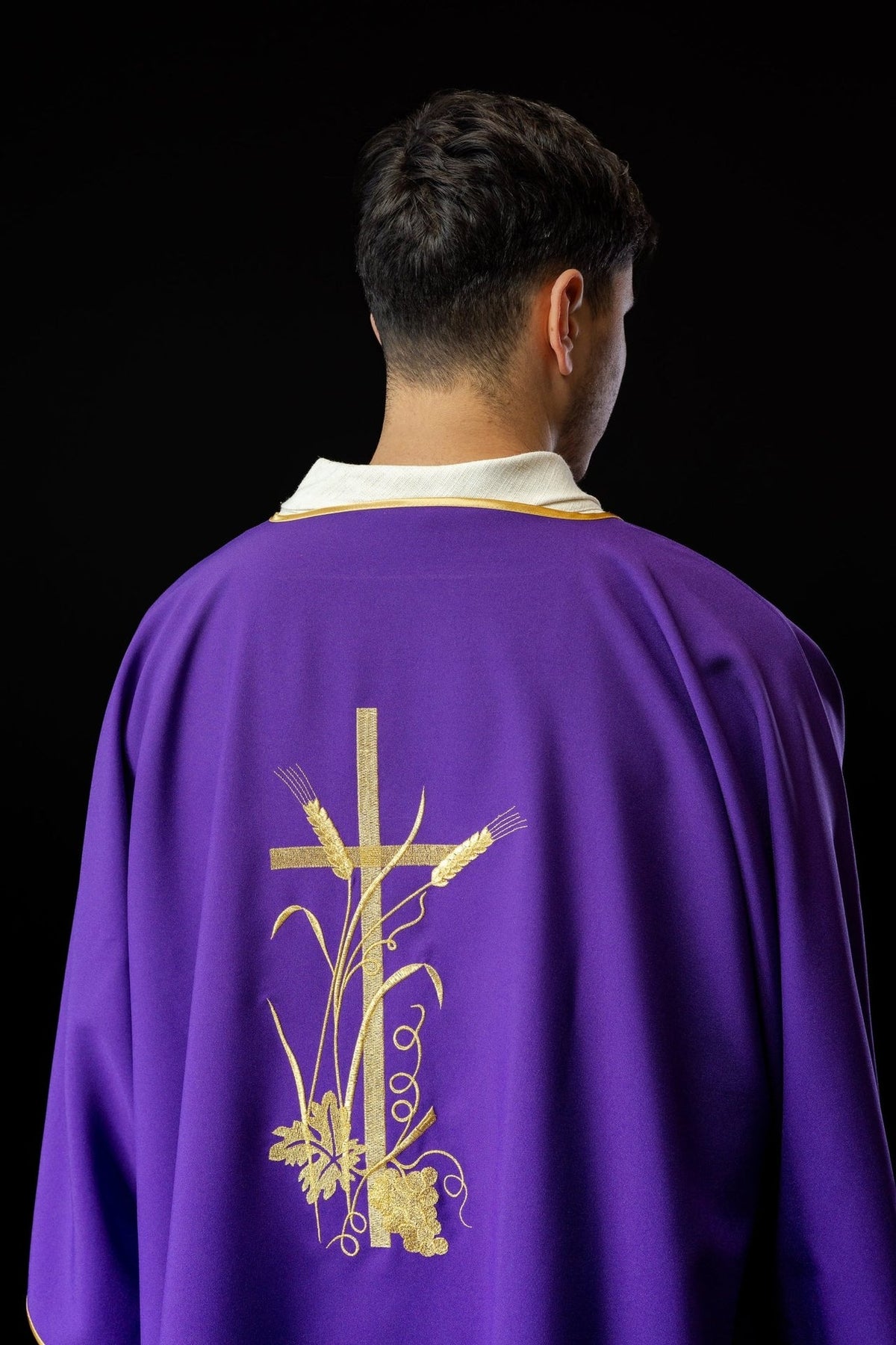 Purple dalmatic shown from the back with gold cross and wheat and grape embroidery