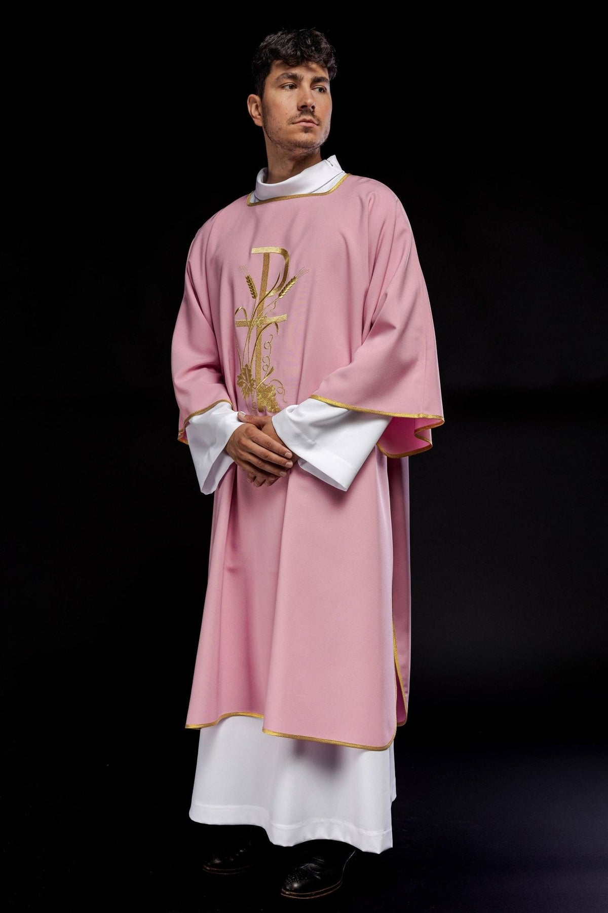 Rose dalmatic angled front view with gold trim and embroidery