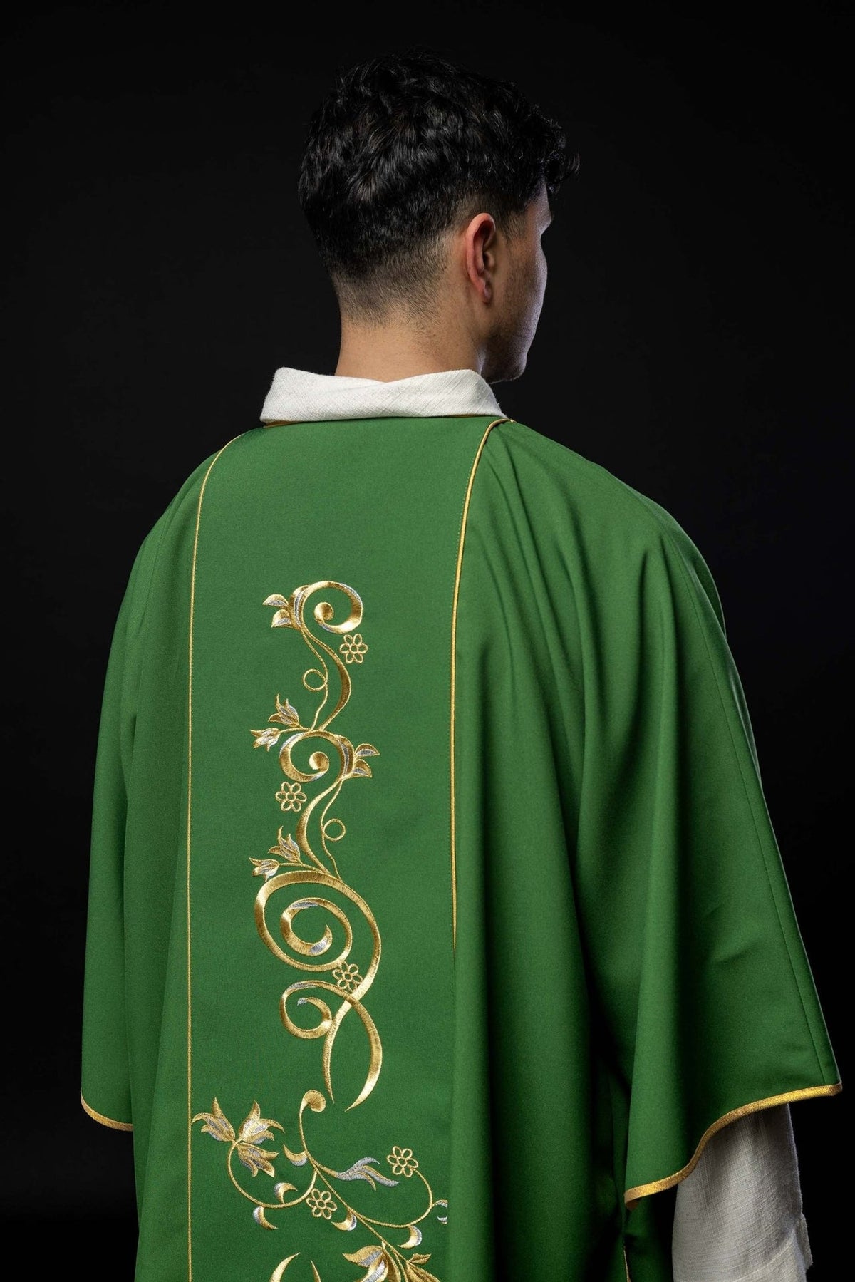 Green dalmatic, back view with gold floral embroidery on the orphrey