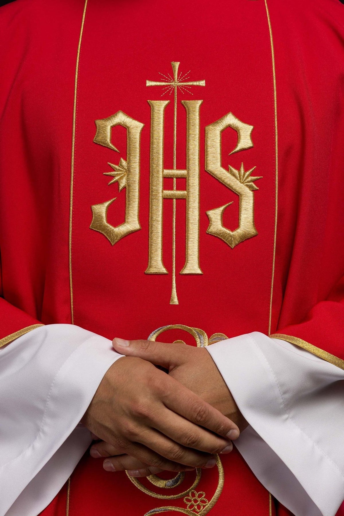 Red dalmatic close-up of embroidered gold IHS orphrey