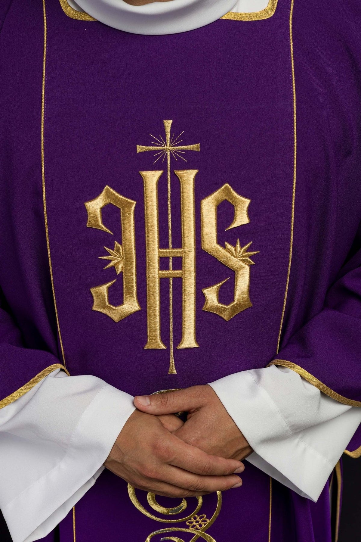 Purple dalmatic close-up of embroidered gold IHS motif and trim