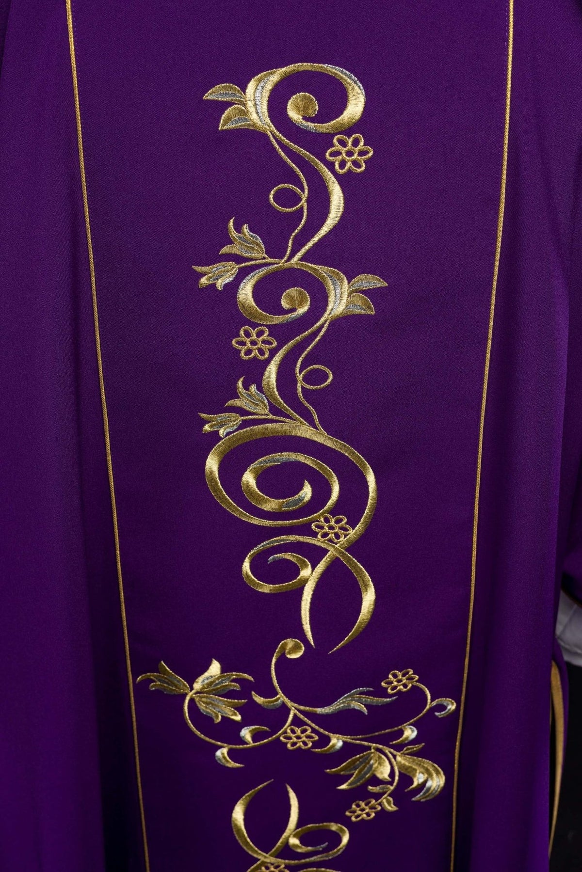 Purple dalmatic close-up of gold floral embroidery on the front orphrey
