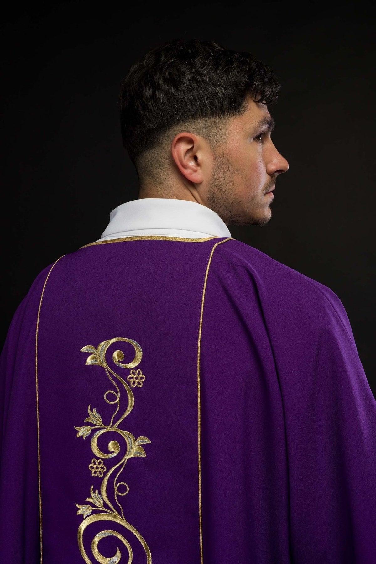 Purple dalmatic back close-up with gold floral embroidery and trim