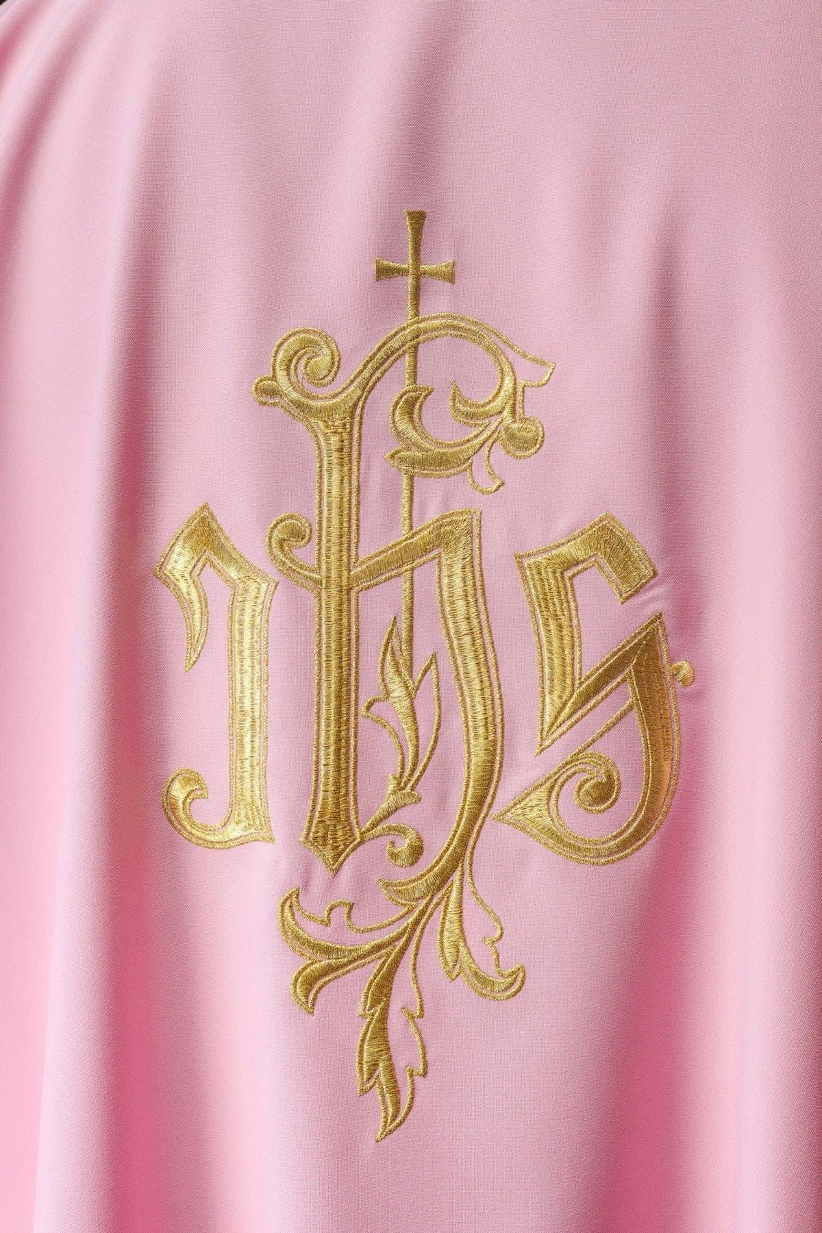 Rose dalmatic close-up showing detailed gold IHS embroidery